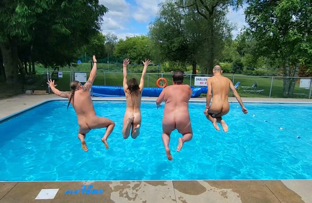 Naked people jumping into the pool at Bare Oaks Family Naturist Park